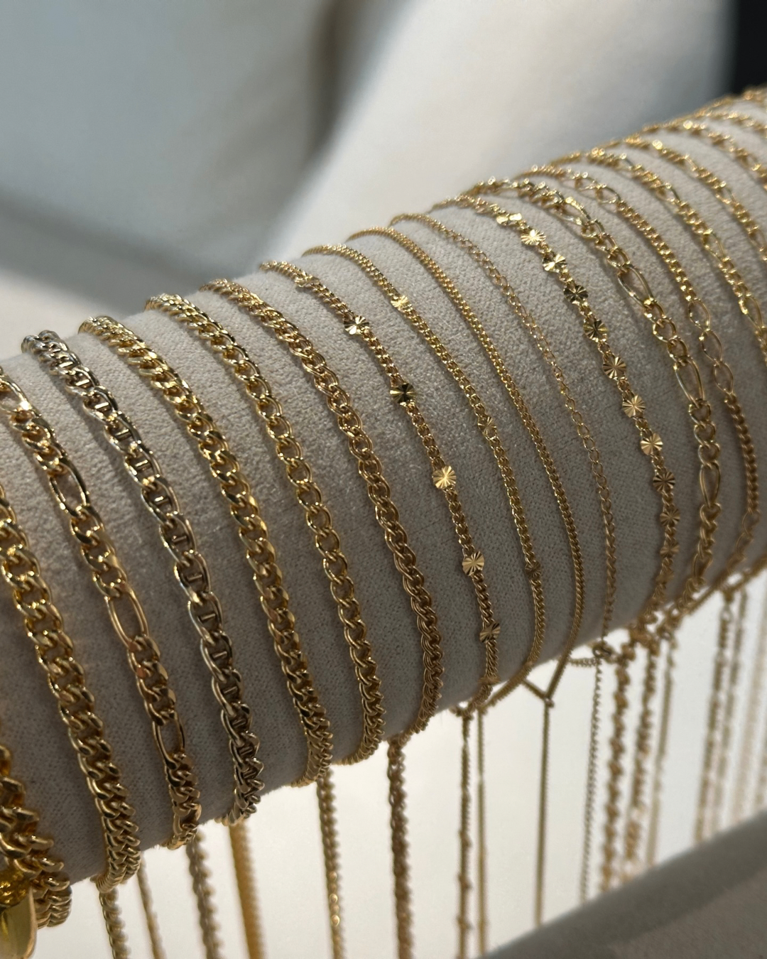 Assortment of gold and silver chain styles on velvet